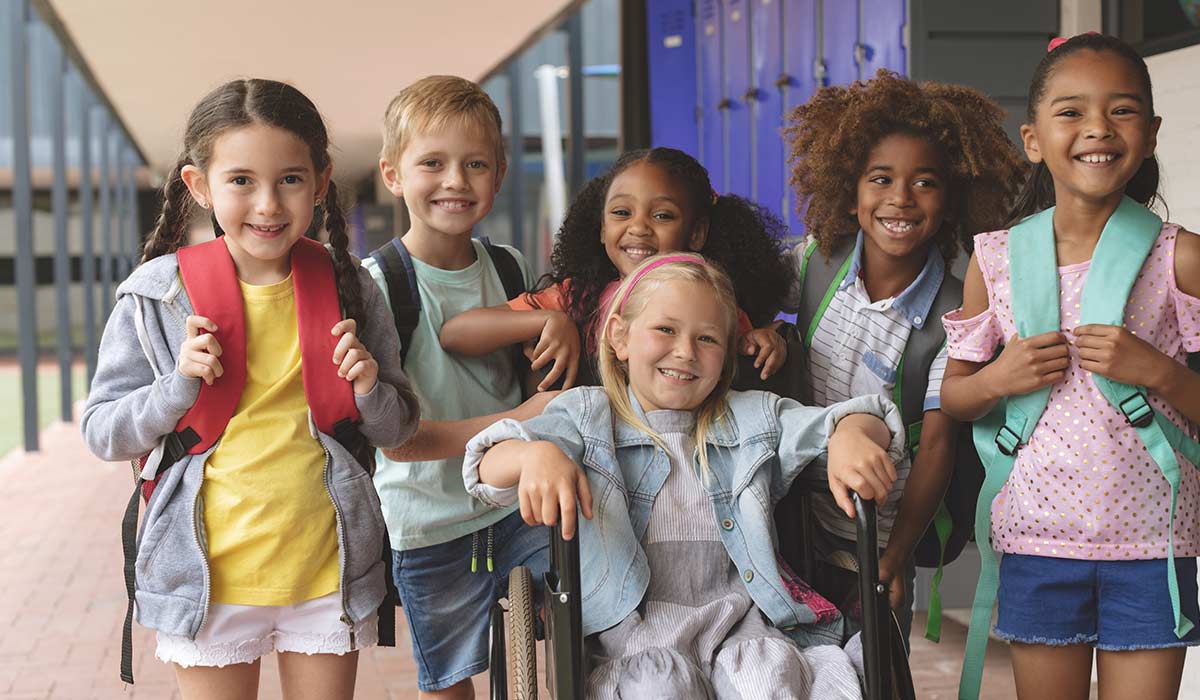 A grid of many young children smiling and happy