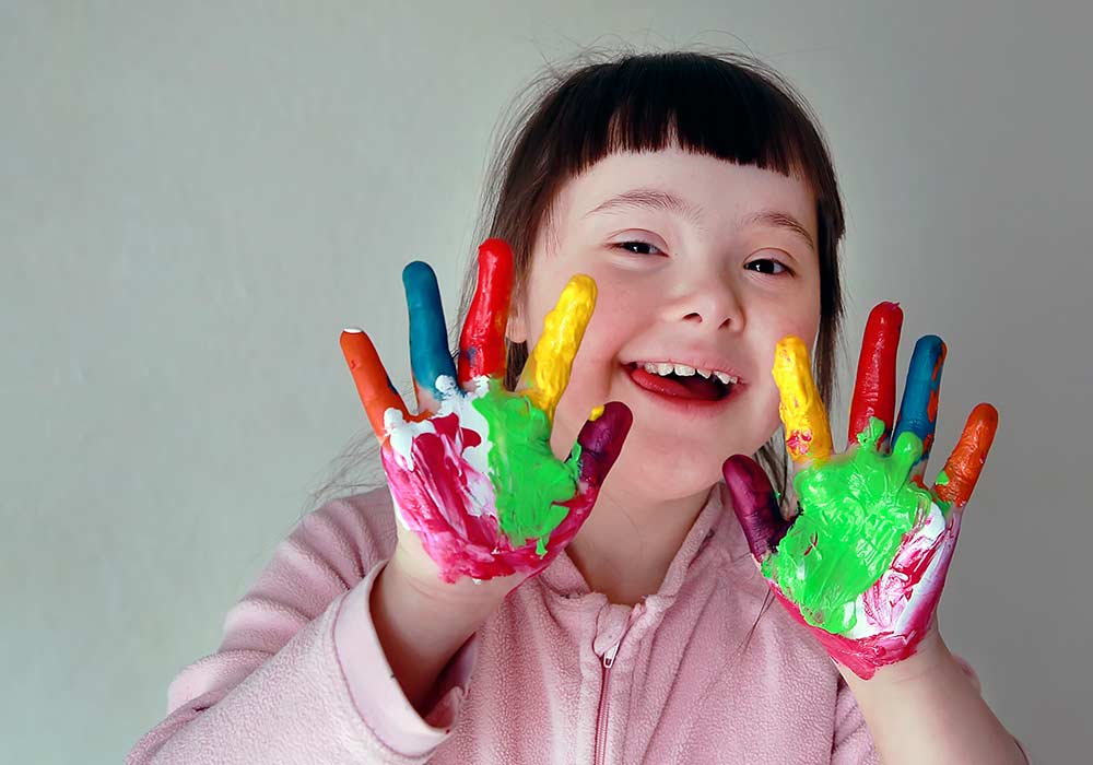 Cute little girl with painted hands.